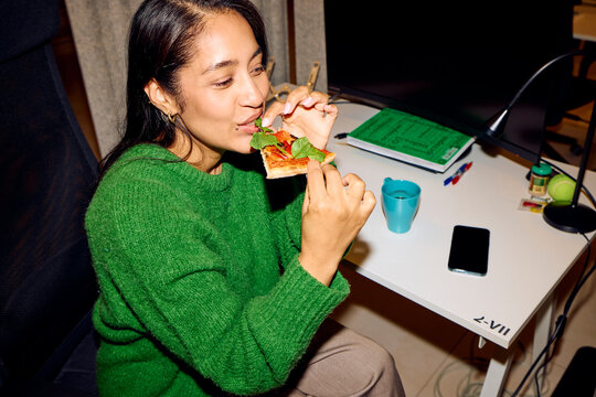 Woman enjoys pizza at work