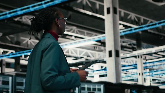 Writing code, tablet and female programmer walking in data center, compiling software patches. Running programming script, device application and African american woman in server hub, camera B