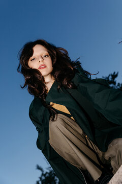 Woman wearing dark green trench coat