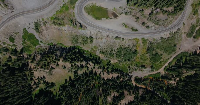 Top down aerial of dramatic mountain switchbacks carved into steep alpine terrain, Million Dollay Highway Colorado USA