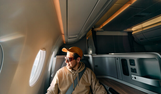 Passenger sitting by airplane window during flight