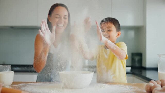 The Flour Fight. Home Cooking & Family Bonding in the Kitchen. Family / Playful. a mother and son playfully bopping each other with floury hands while making cookies, clouds of white flour in the air
