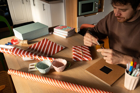 Man finishing wrapped gift