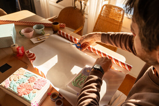 Man cutting wrapping paper