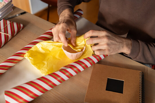 Man wrapping small gifts