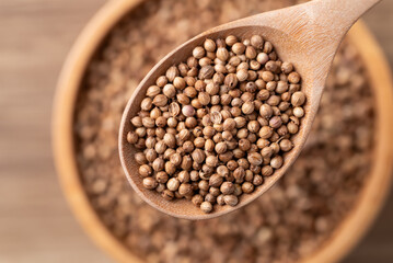 Coriander seeds in a wooden spoon, Top view of Thai food ingredients