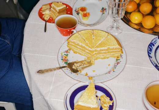 Gathering With Cake and Tea at a Table With Citrus Fruits