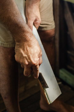 Home restoration, Hands using a chisel to remove paint