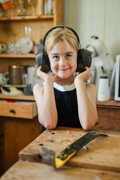 A young girl in sound blocking ear muffs