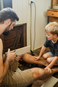 A father teaching his son about timber restoration