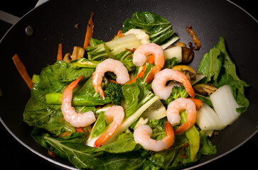 Cooking a Shrimp Vegetables Stir Fry in a Wok on the Stove
