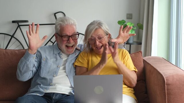 Excited senior mature couple surprised by good unbelievable news, unexpected win, huge shopping sale offer on website, astonished older middle aged family looking at computer screen feeling amazed
