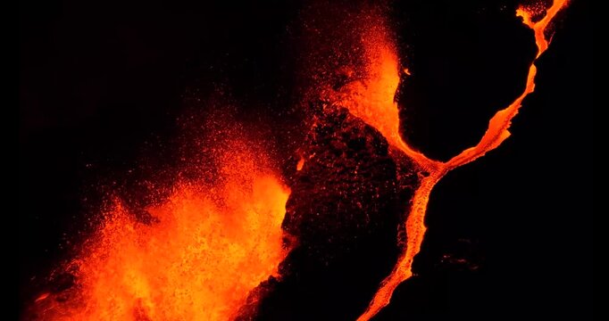 Cinematic aerial view of Piton de la Fournaise volcano eruption with flowing lava