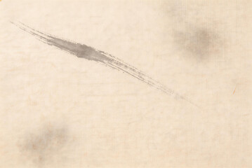 Abstract ink brush stroke on vintage paper texture, artistic background with grunge and textured details, suitable for design elements.