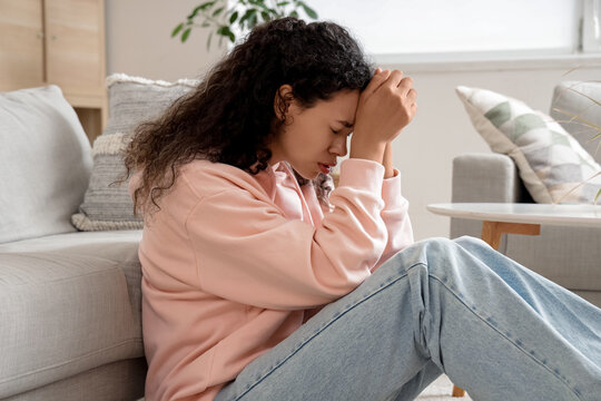 Young African-American woman having panic attack at home