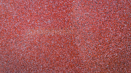 Fototapeta premium Close-up of rough textured red terrace ceramic tiles with granular anti-slip surface. Outdoor flooring detail suitable for background, pattern, and architectural material concepts.