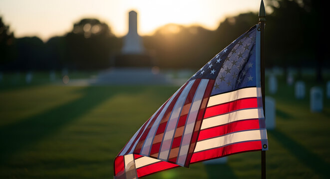 American flag in a military cemetery with headstones and monumen