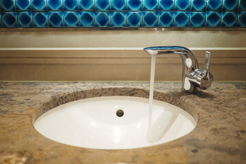 Water flows from a faucet in a bathroom sink
