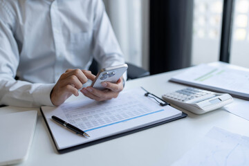 Fototapeta premium Businessman using smartphone for working in office room