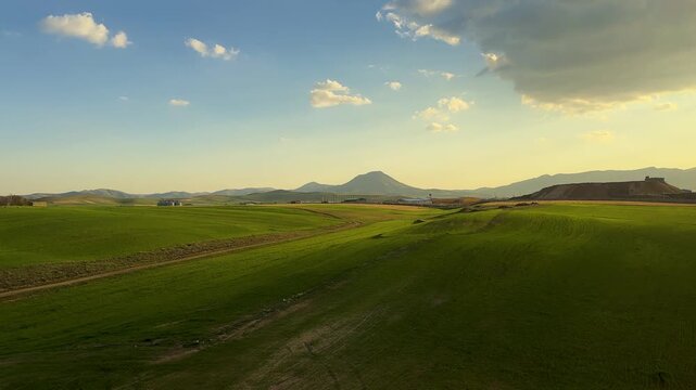 green hills landscape aerial scenic panoramic sunset mountain road trip Train Kurdistan Azerbaijan blue sky rural countryside yellow canola fields blooming agriculture sustainable farming Trip to Iran