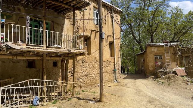 mountain village rural town in Iran Kurdistan mud brick traditional terrace cascade slope countryside scenic travel local people nomad agriculture wheat barley grain farm field golden summer landscape