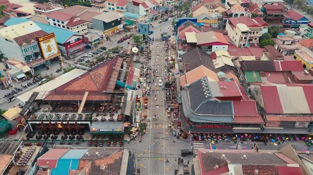 Aerial drone video of Central Market district in Phnom Penh showing busy streets shops buildings traffic and active city life reflecting commercial urban atmosphere in Cambodia