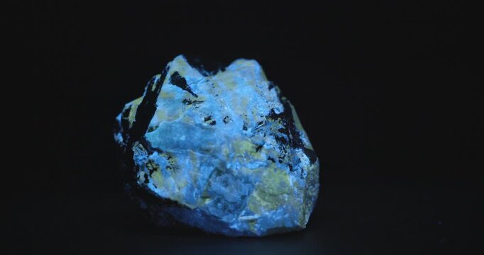 Scheelite Wolframite and Powellite rock Glowing Blue Under UV