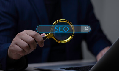 Businessman holding magnifying glass over virtual search bar with SEO text. Concept of Search Engine Optimization, digital marketing, and website ranking strategy.