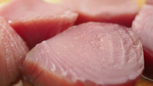 Close-up of Fresh Raw Tuna Steaks on a Wooden Board
