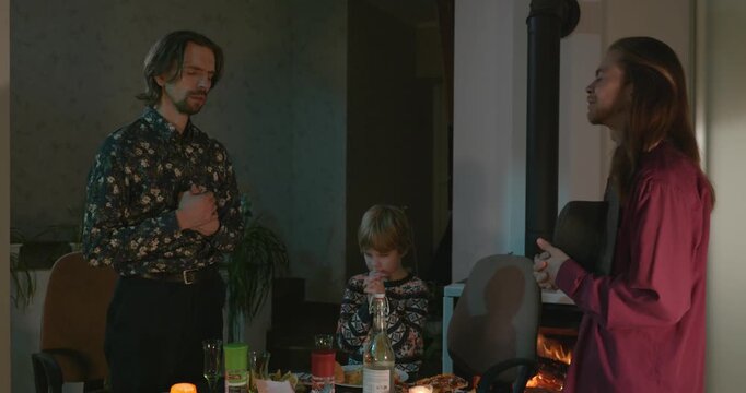 Men Friends and Kid Boy Pray Before Dinner. 4K 10-bit