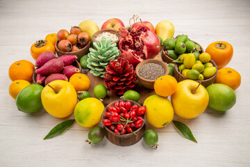 front view fresh fruits composition different fruits on a white background tasty health citrus tree color berry diet exotic © Studio