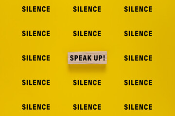 silence words and single speak up word. isolated on yellow background. concept of advocacy © Dadan