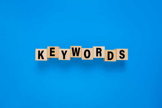 keywords word on wooden blocks. isolated on blue background