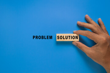 male hand put problem and solution words. isolated on blue background. concept of problem solving © Dadan