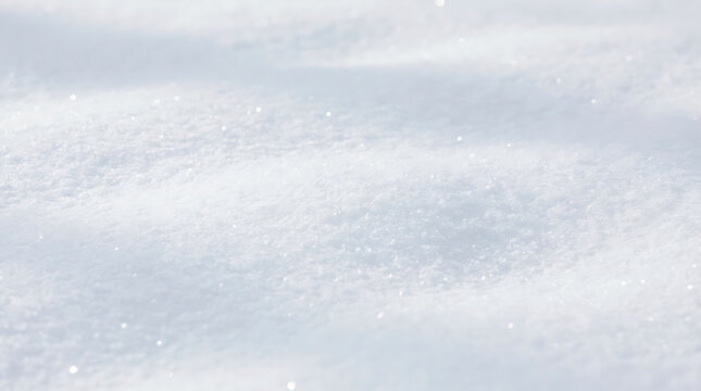 Snowflakes falling on snow-covered ground from aerial viewpoint