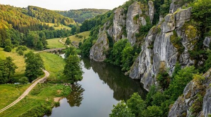 Tranquil river winding through green landscapes and gray cliffs