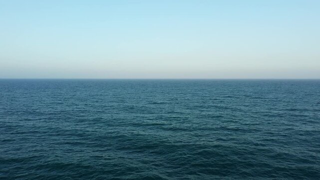 Wide view of the tranquil Mediterranean Sea under a clear blue sky, with gentle waves and an open horizon. Perfect for concepts of serenity, travel, and nature.