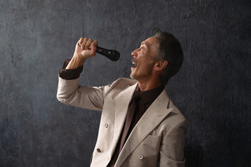 マイクを持って熱唱するシニア男性　ライフスタイルイメージ