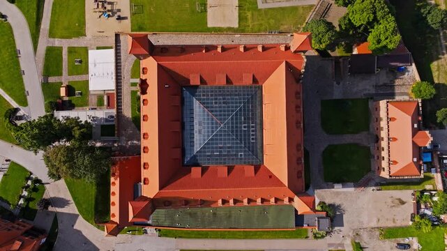 Drone ascends above Gniew Castle revealing perfect symmetry and layout
