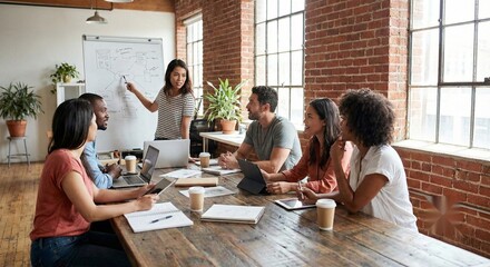 Diverse creative team brainstorming in modern industrial office