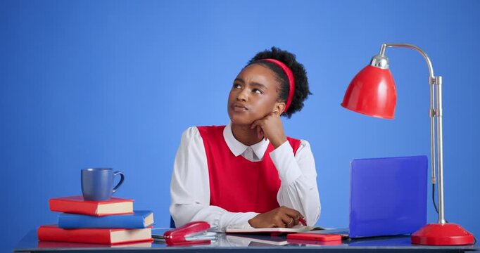 Serious, student and woman with laptop, decision and planning for assignment with research or space. Blue background, reflection and black person with notebook for quiz, reading and ideas in studio
