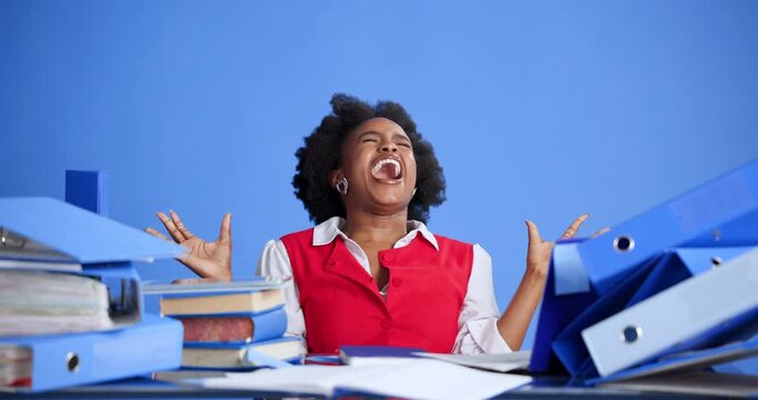 Stress, scream and black woman with documents for overworked, burnout or fatigue with finance project. Paperwork, shouting and African female financial advisor with admin chaos by blue background.