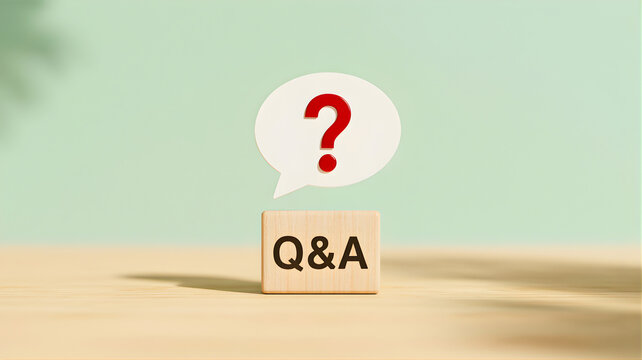 A wooden block with Q&A and a question mark on a speech bubble on a light brown surface against a pastel green background from a straight viewpoint like 9.jpg