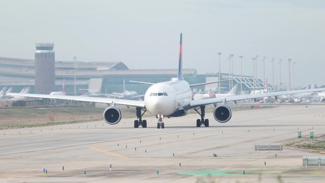  Airplane is preparing for takeoff on the runway in an airport of Barcelona. High quality 4k footage