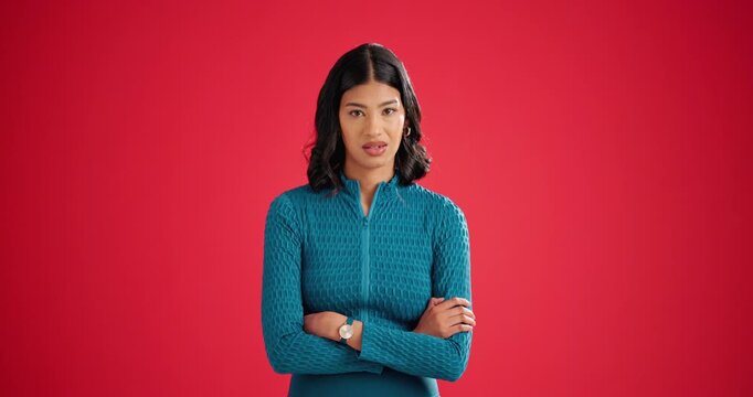 Face, angry and woman in studio, arms crossed and facial expression on red background. Space, emotional rage and person with reaction for news, moody and upset for stress, frustrated and furious