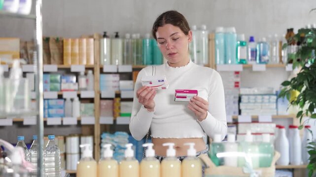 Female buyer buys paracetamol medicine at a pharmacy. High quality 4k footage