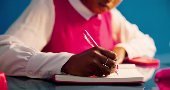 Business woman, hands and writing for planning, productivity and project management in studio. Aesthetic, journalist and employee with notebook, research and creative publisher on blue background