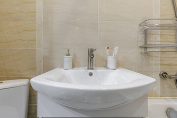 Fototapeta premium Modern Bathroom Sink with Soap Dispenser and Toothbrushes