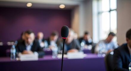 Fototapeta premium Blurred conference room scene with microphone in foreground