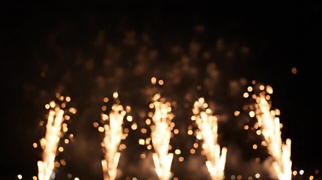 Beautiful golden fireworks exploding in the night sky with bokeh